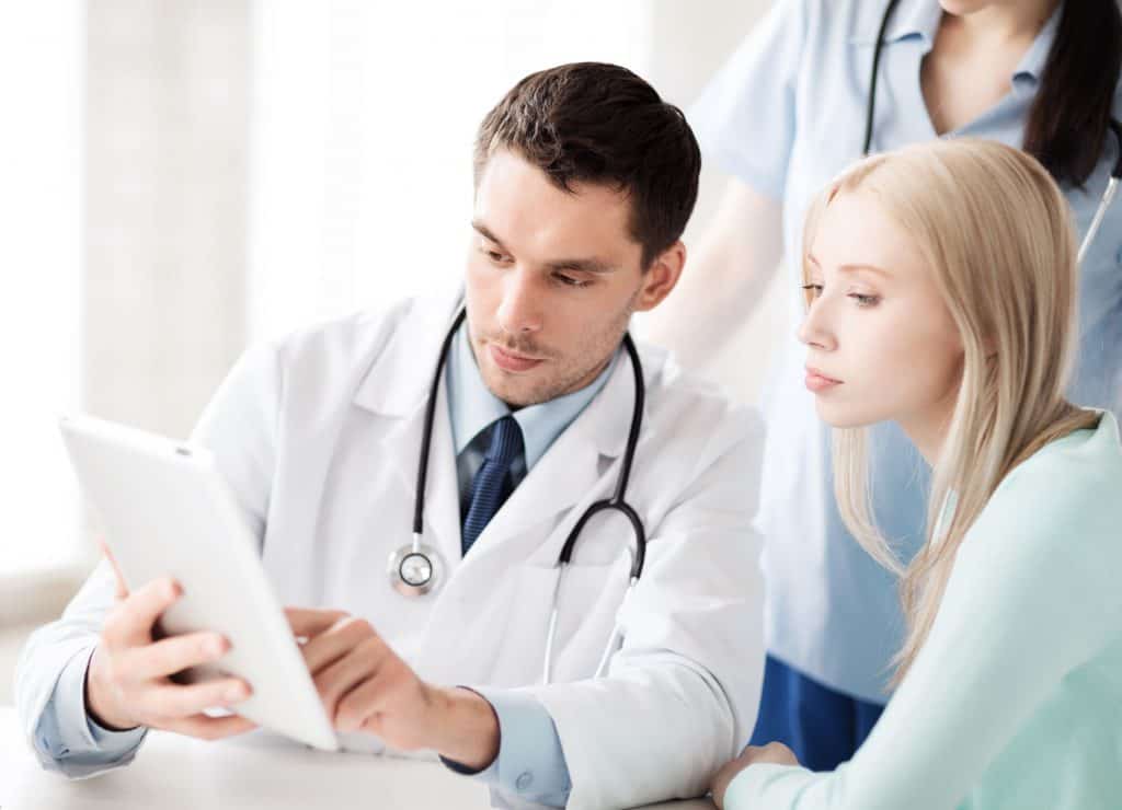 a healthcare, practitioner consulting with a patient
